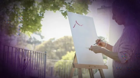 Woman painter starting red marks on canvas, layering to build art with purple Video stock 333552666