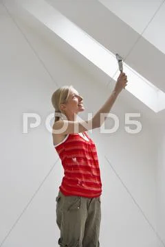 Woman Painting Ceiling Slope Stock Photos