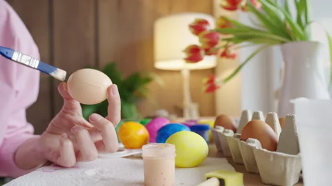 Woman painting Easter egg at home with pastel paints Stock Footage 330803853