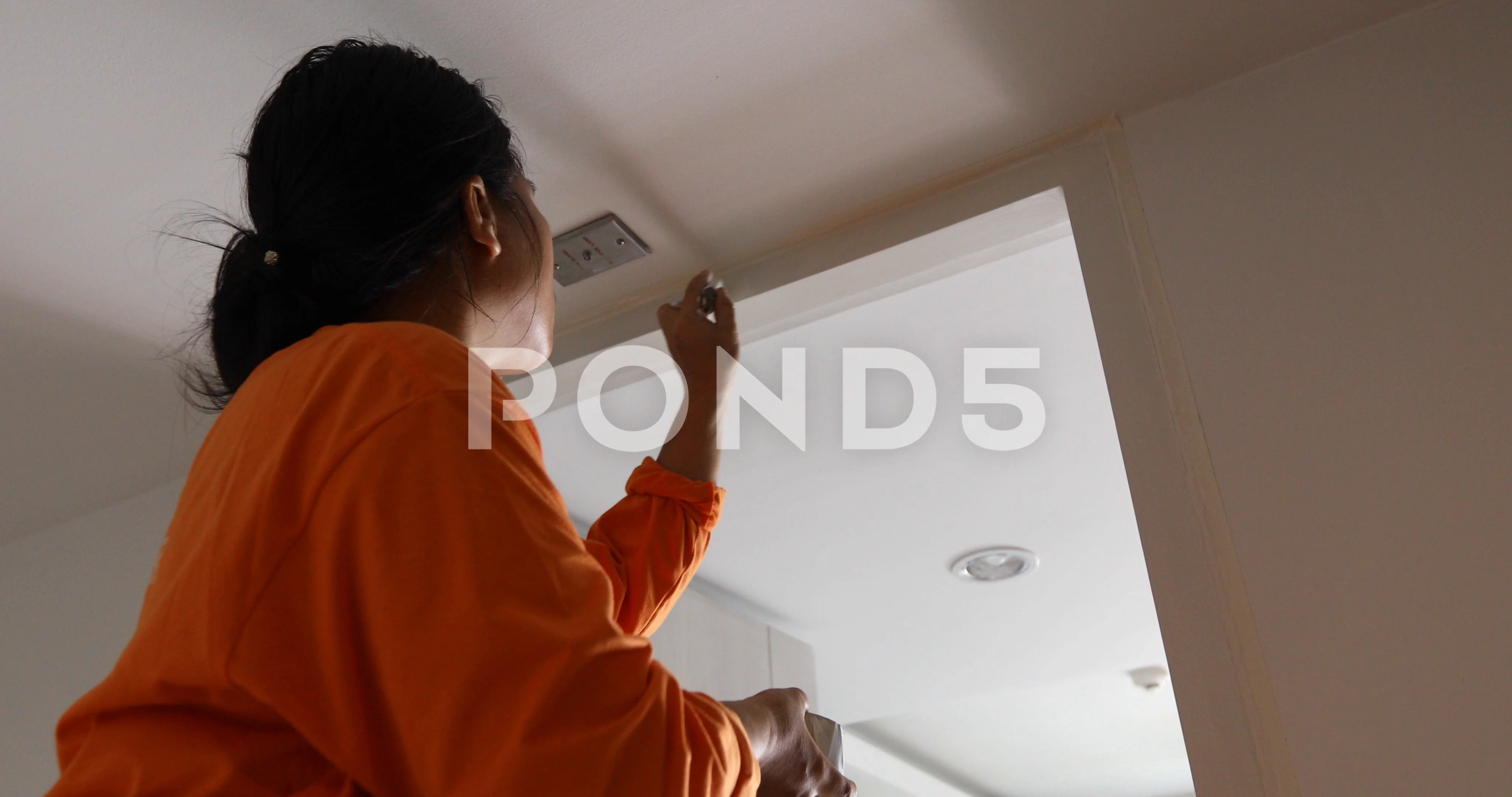 Woman Painting The Edges Of The Ceiling With Paintbrush Clip