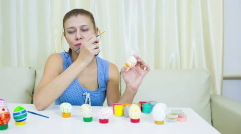 Woman paints on Easter egg Stock Footage 60821405