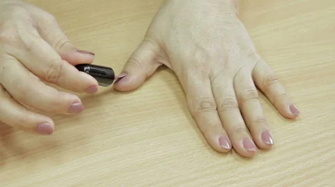 Woman paints his nails herself Stock Footage 59791348