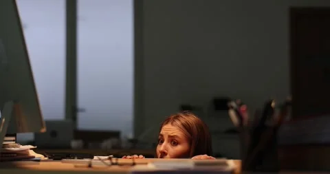 Woman with panic attack hides behind desk in office Stock Footage 280601460