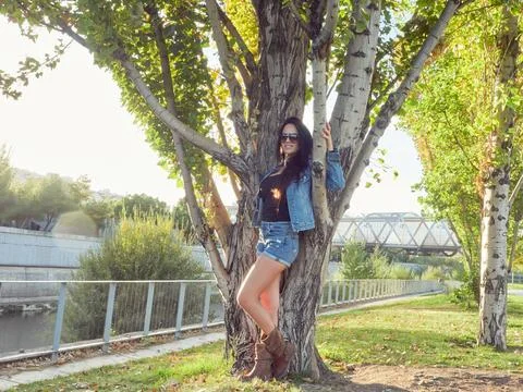 Woman in park next to a tree. Stock Photos