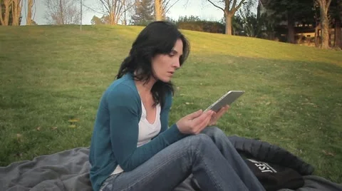 Woman in park using tablet computer Video stock 22024999