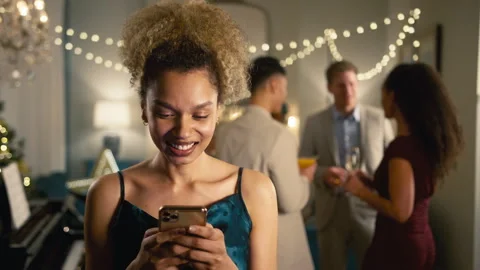 Woman At Party Checking Social Media Or Messages On Mobile Phone Stock Footage 251876953