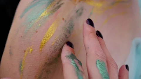 A woman with a pattern on her face, applied with special bright body paints Stock Footage 163152758