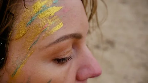 A woman with a pattern on her face, applied with special bright body paints Stock Footage 163152803