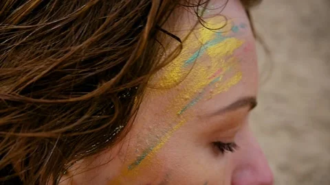 A woman with a pattern on her face, applied with special bright body paints Stock Footage 163293057