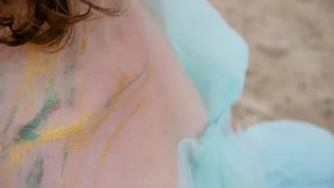 A woman with a pattern on her face, applied with special bright body paints Stock Footage 163293237