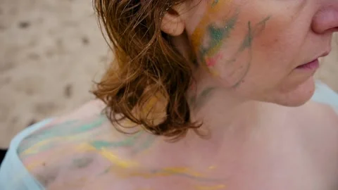 A woman with a pattern on her face, applied with special bright body paints Stock Footage 163293334
