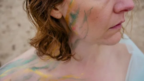 A woman with a pattern on her face, applied with special bright body paints Stock Footage 163293425