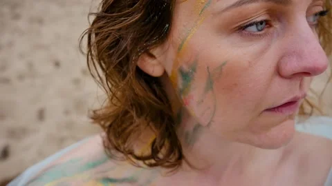 A woman with a pattern on her face, applied with special bright body paints Stock Footage 163293569