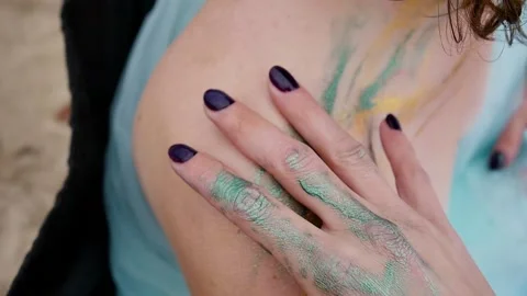 A woman with a pattern on her face, applied with special bright body paints Stock Footage 163293610