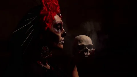 A woman with a pattern on her face in the style of the Goddess of Death with a Stock Footage 229842698