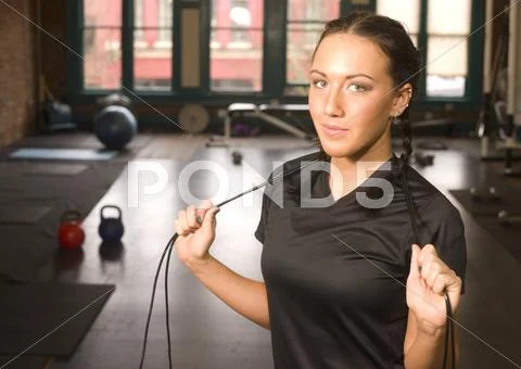 Woman pauses during rope work at fitness boot camp Stock Photos