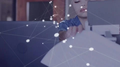 Woman pausing typing pulling papers and checking sheet to tech laptop as network Stock Footage 334883909