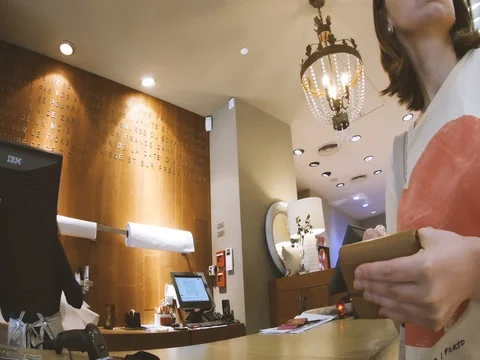 Woman paying at the counter in design Zara store Stock Footage