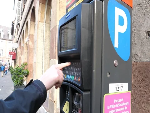 Woman paying for parking at the new Parking ticket payment machine Stock Footage