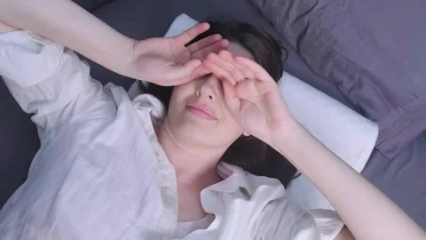 Woman peacefully sleeping on a comfortable memory foam pillow, reducing the risk Stock Footage 299723385