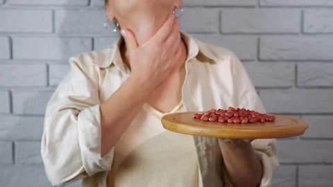 Woman with a peanut allergy choking Stock Footage 330670153