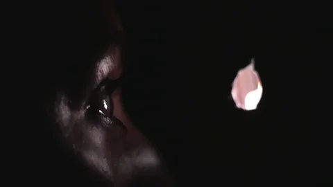 A woman peeks, spy through the hole in the wall. spying on neighbors. 4k Stock Footage