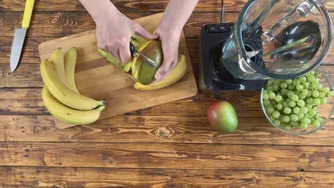 The woman is peeling a mango Stock Footage 106370344