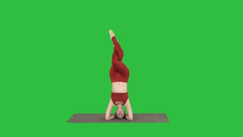 Woman performing a headstand with split on a Green Screen, Chroma Key. Stock-Footage 99365583