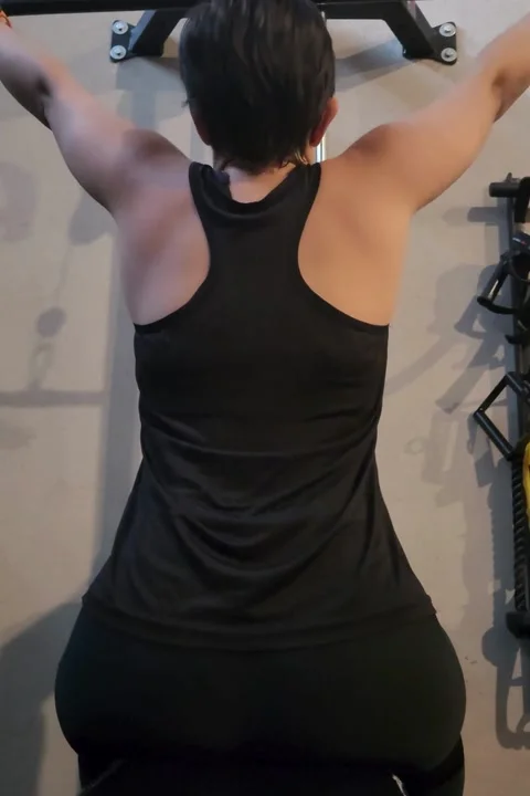 Woman performing lat pulldown exercise Stock Footage 315005308