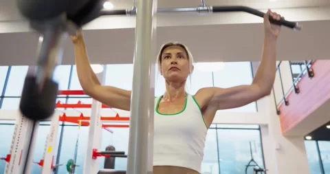 Woman Performing Lat Pulldown Exercise at Gym Stock Footage 323626694