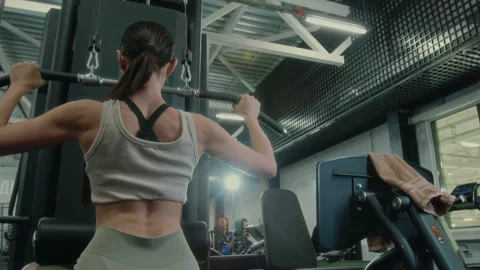 Woman Performing Lat Pulldowns on Gym Machine Stock Footage 285656318