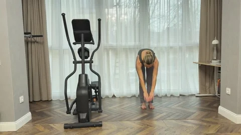 Woman performing repeated toe touch stretches in sets at home, Concept of Video stock 341866243