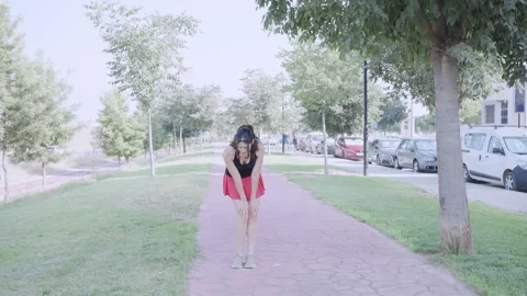 Woman Performing Standing Forward Bends During Outdoor Warm-Up Видео 345083490