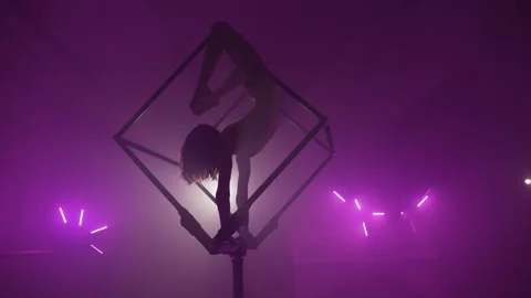 Woman Performing Tricks Inside a Cube in Darkness Stock Footage 295215550