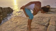 Woman Performing Yoga On Rock Near Seaside During Sunset Stock Footage