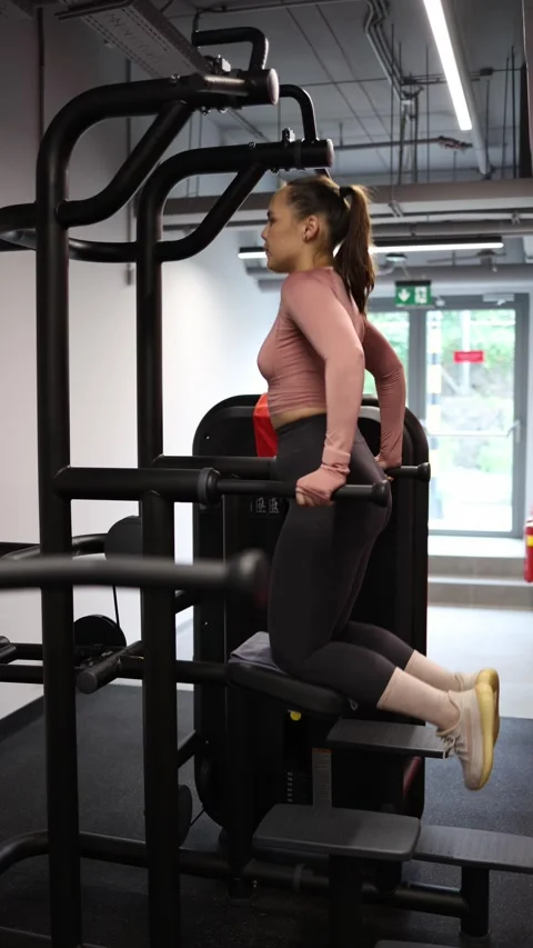 Woman performs assisted dips Stock Footage 337956819