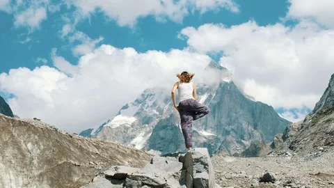 Woman performs an basic asana tree - vriksasana in yoga on a background of a 스톡 동영상 95342360