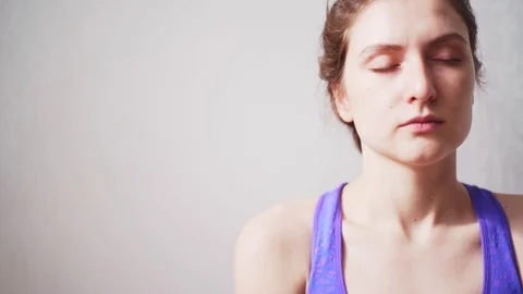 A woman performs breathing exercises during a fitness break. Cleansing the mind Stock Footage 128975607
