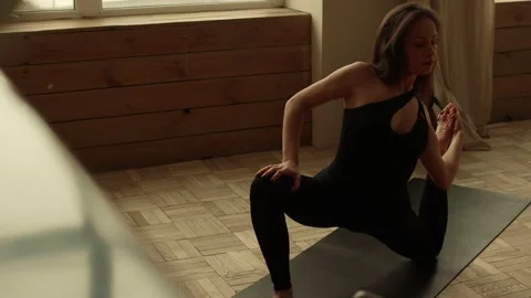 Woman performs complex element of yoga Stock Footage 170746754