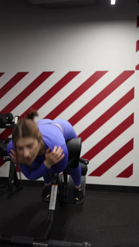 Woman performs core exercise on gym machine Stock Footage 328253689