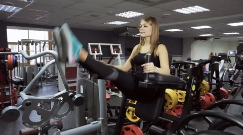 A woman performs an exercise on pumping up press on simulator Stock-Footage 64568900