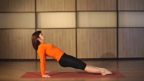 A woman performs exercises to stretch Stock Footage 81694871