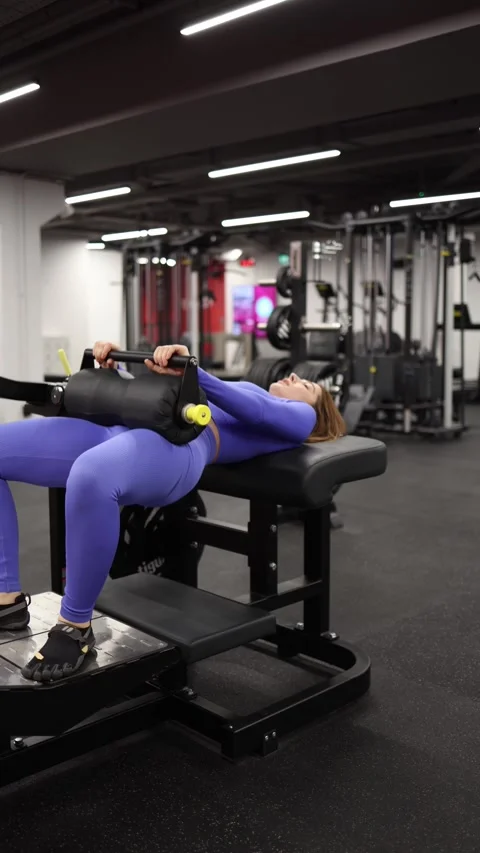 Woman performs hip thrust exercise during gym workout Stock Footage 328253726