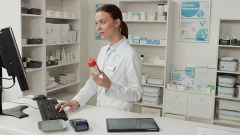 Woman Pharmacist using Computer Stock Footage 335609383