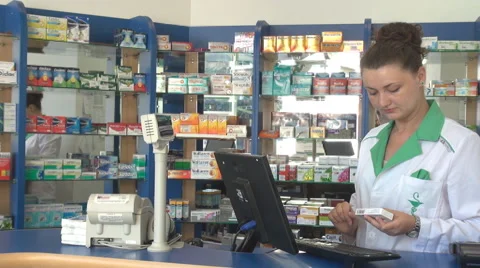 Woman pharmacist working, data input in desktop computer, pills description view Stock Footage 40445364