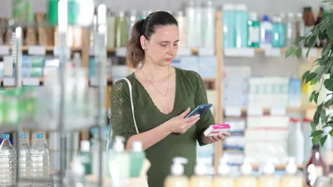 Woman in pharmacy scans QR code tablet paracetamol medication product Stock Footage 317528690