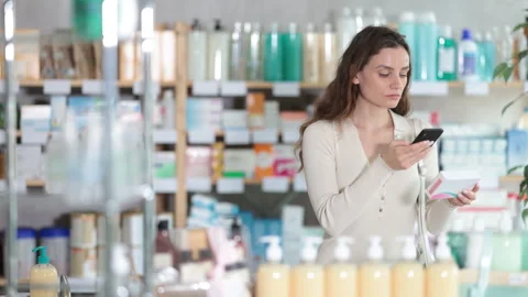 Woman in pharmacy scans QR code on pills box Stock Footage 329542901