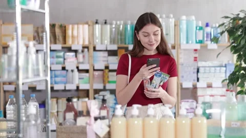 Woman in pharmacy scans QR code on toothbrush Stock Footage 330402449