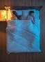 The woman phone on the bed near the husband. night time. view from above Photo