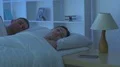 The woman phone on the bed near a man. Camera around motion 4k or 4k+ Resolution
